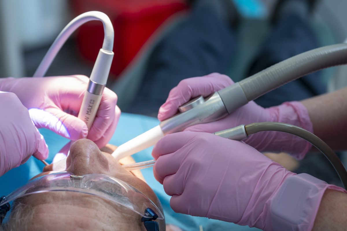 Dental therapist working with Airflow as part of a full check-up and hygiene appointment